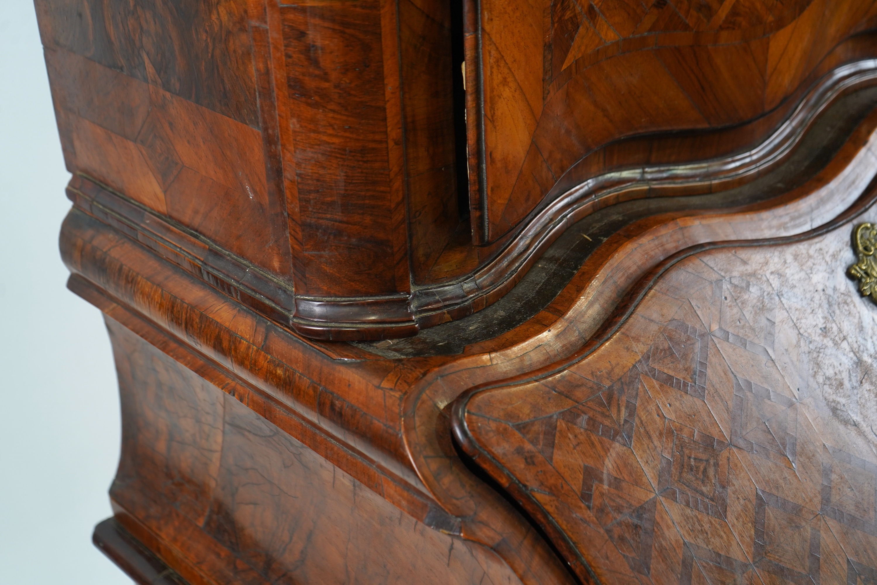 A mid 18th century North Italian or Maltese walnut and olive wood gilt metal mounted serpentine bureau cabinet
